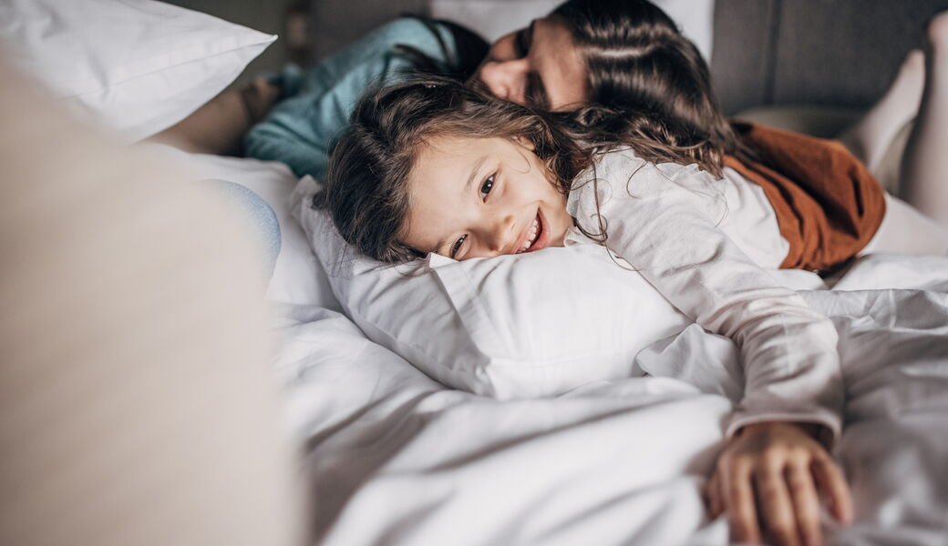 A family enjoys a guest room at the John Carver Inn and Spa in Plymouth MA