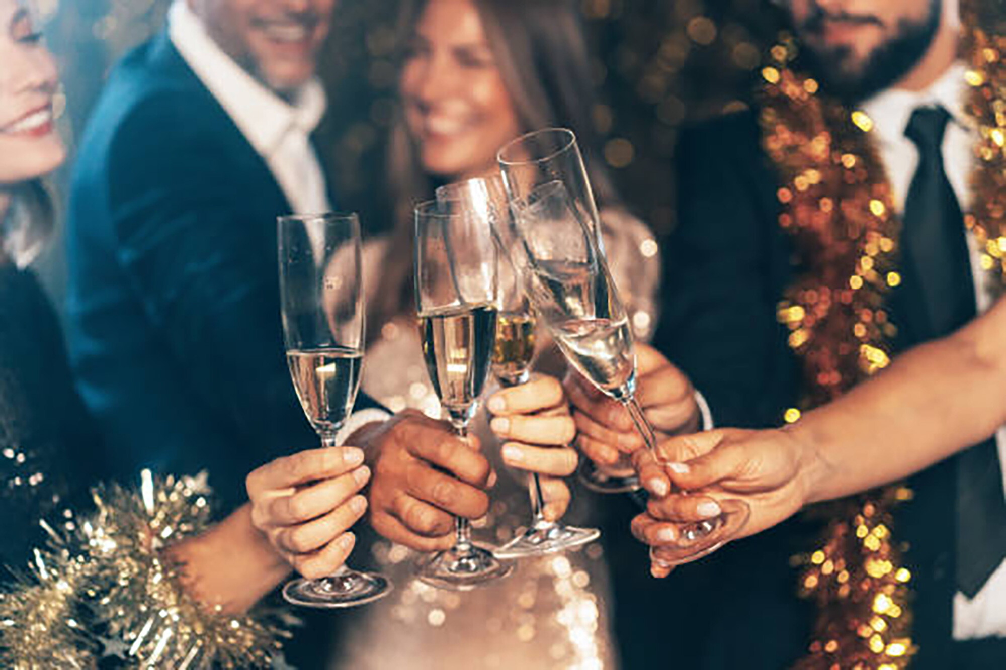 A group of friends clinking champagne flutes at the John Carver inn and Spa, Plymouth MA