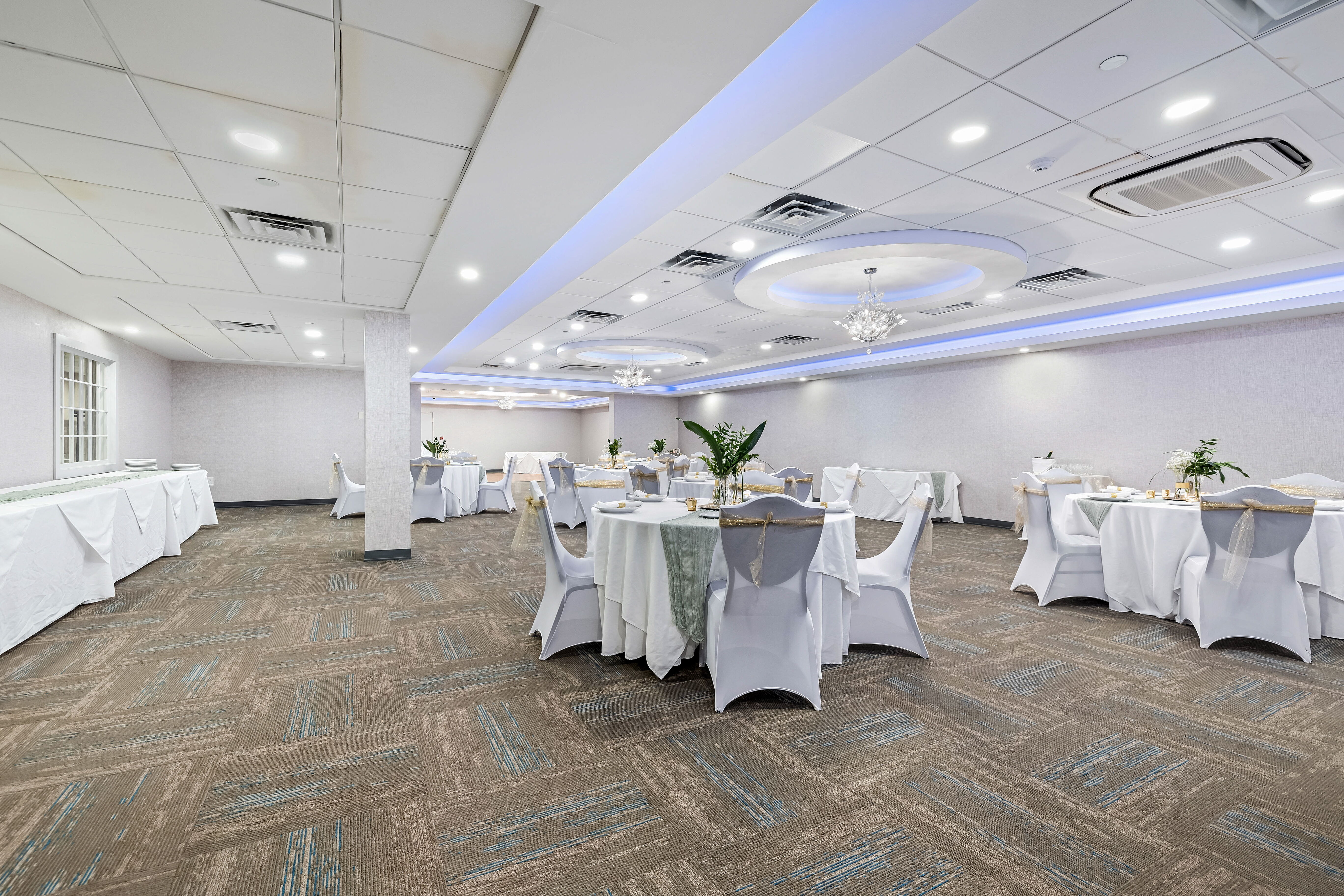 Banquets and Events at the John Carver Inn & Spa - A fully set event room with tables and chairs