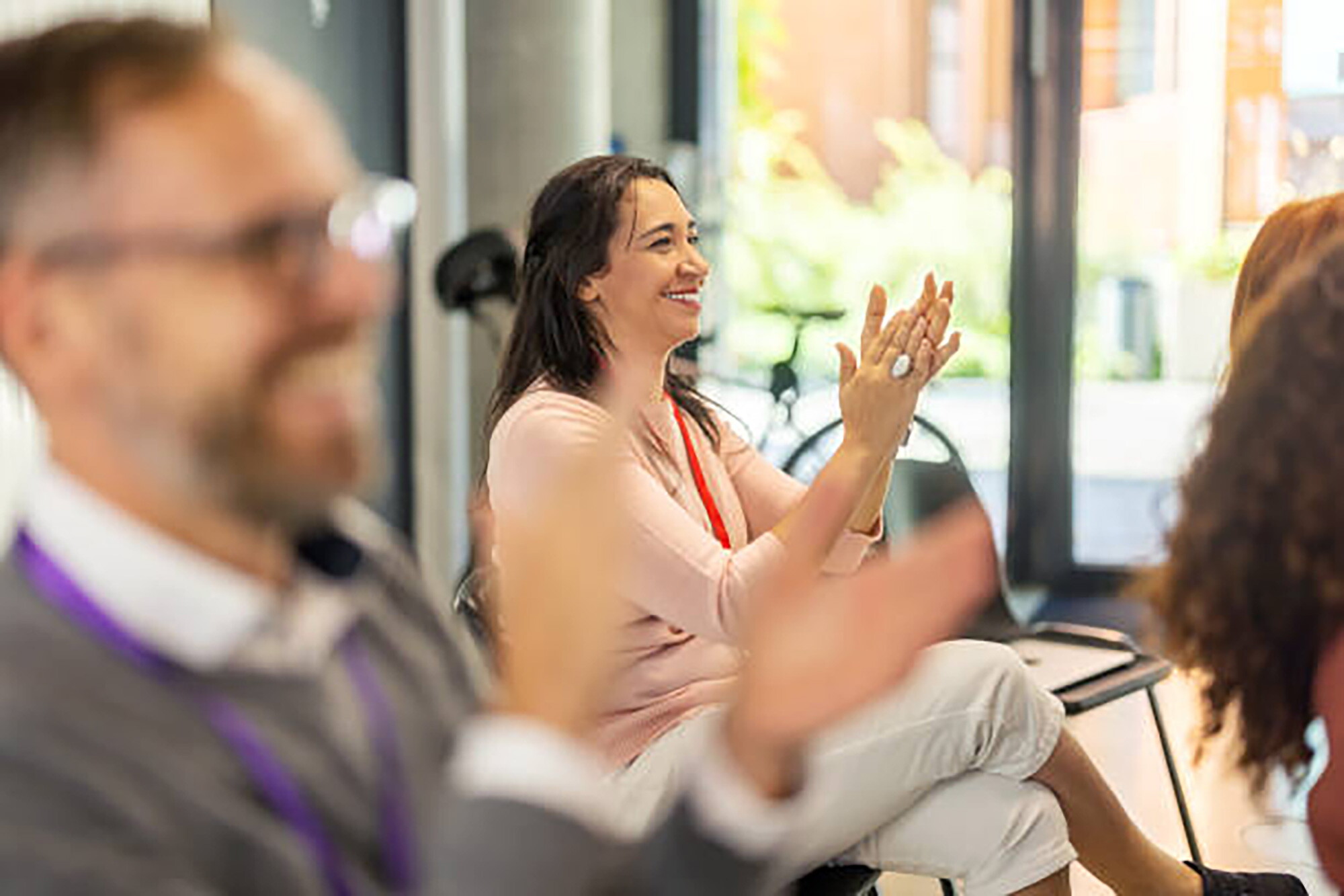 A woman claps at a company meeting at the John Carver inn and Spa, Plymouth MA