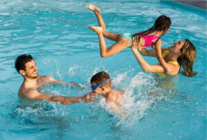 Family having fun in the pool at John Carver Inn and Spa, a hotel in Plymouth MA